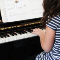 girl piano student practicing the piano