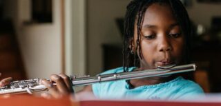 student practicing the flute