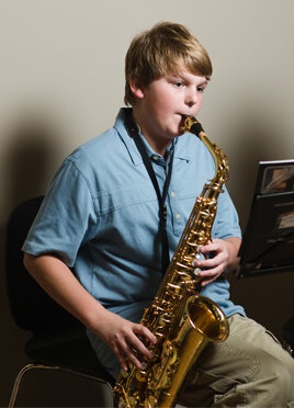 boy playing a saxophone