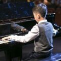 boy playing in piano recital charlotte academy of music